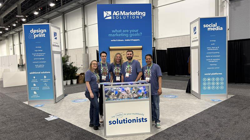 AG Marketing Solutions team at PAA tradeshow with booth behind them
